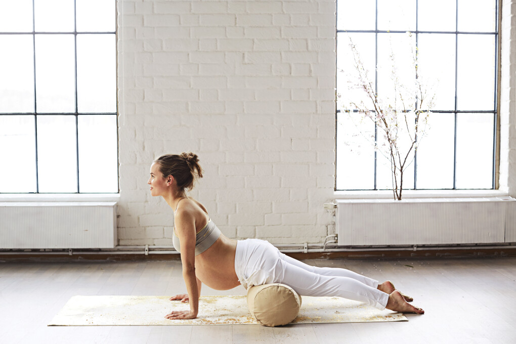 Beautiful pregnant woman does yoga